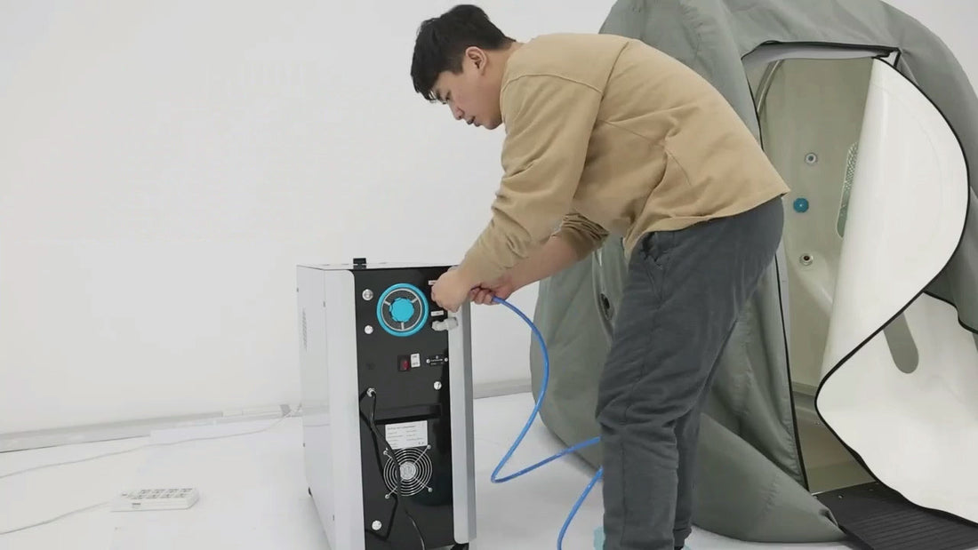 Technician connecting support equipment to an O2BAY portable hyperbaric chamber